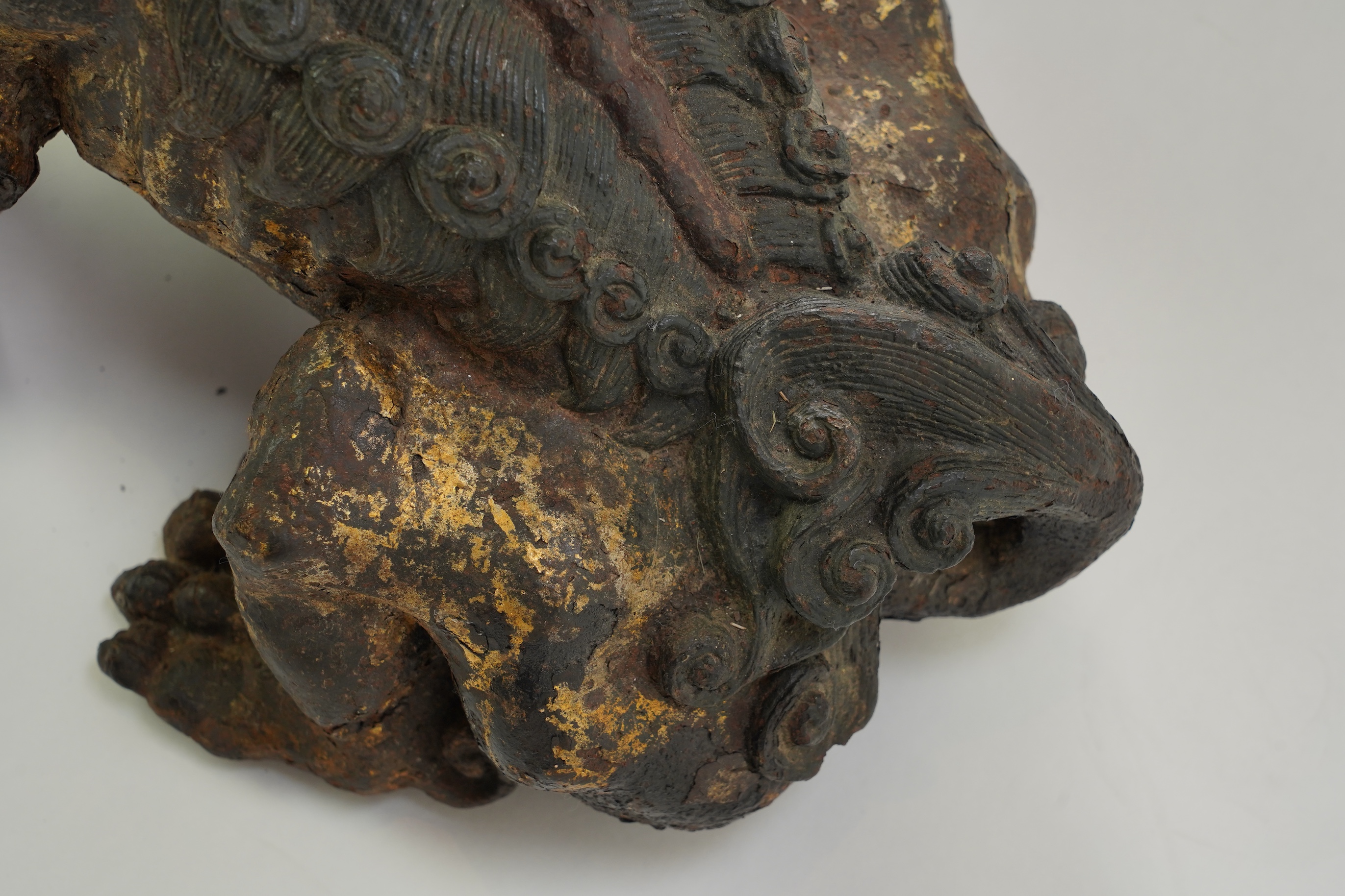 A pair of large Chinese polychrome lacquered cast iron models of lion temple guardians, Qing dynasty